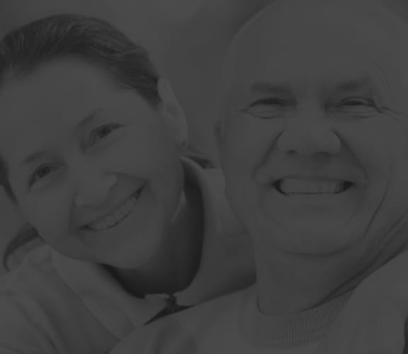 Mature couple with dentures smiling