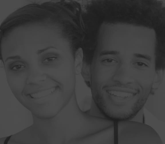 Couple holding each other and smiling at the camera