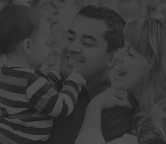 Happy couple looking at their smiling baby