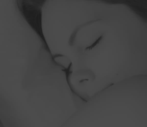 Woman hugging a pillow and sleeping
